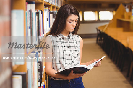 Female student learning from book