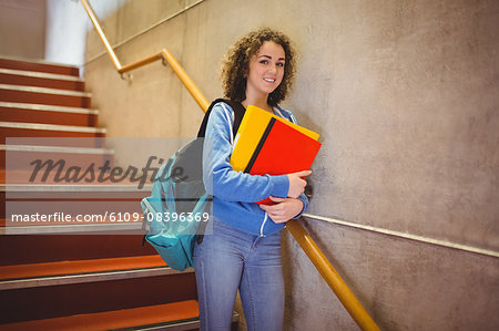 Pretty student walking down steps