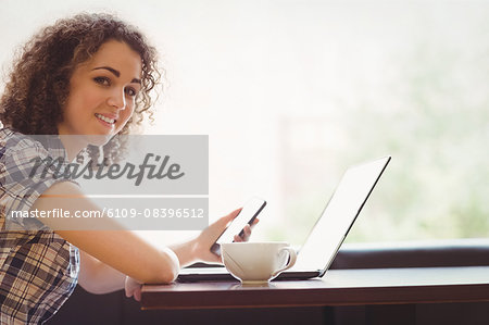 Student having a coffee using laptop