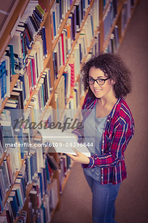 Pretty student in library taking book