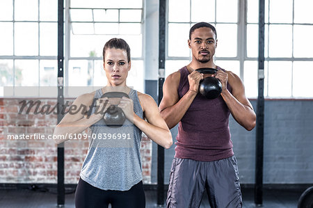 Fit couple lifting kettle bells
