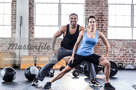 Fit couple doing stretching exercises