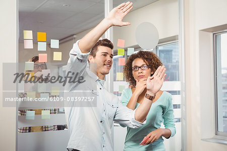 Businessman gesturing while explaining colleague