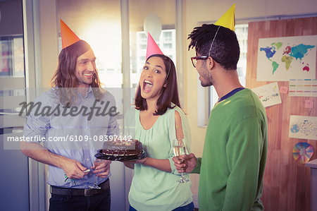 Businesswoman with cake having fun in birthday party