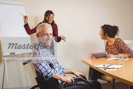 Businessman on wheelchair in creative office