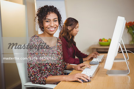 Portrait of businesswoman working on computer