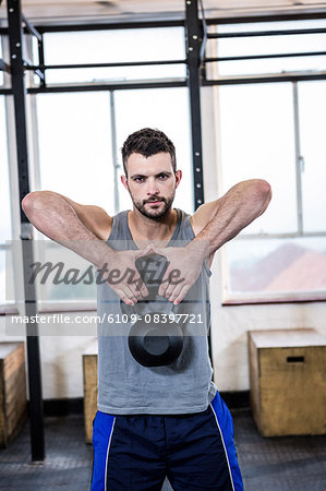 Fit man working out with kettlebell