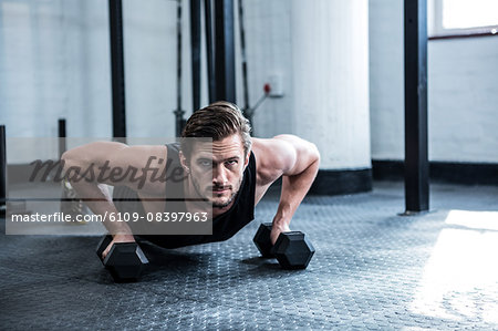 Fit man working out with dumbbells