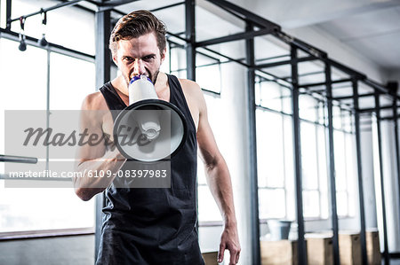 Fit trainer shouting through megaphone