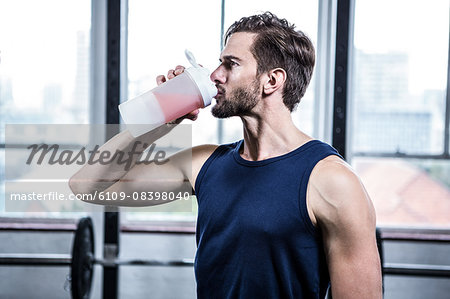 Fit man drinking his protein shake Fit man drinking his protein shake
