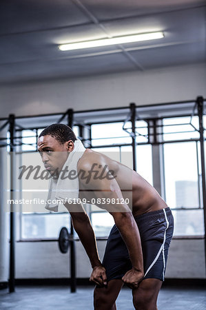 Fit shirtless man with towel on shoulders