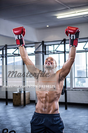 Fit shirtless man with boxing gloves