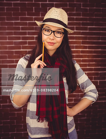 Attractive hipster posing with a pencil