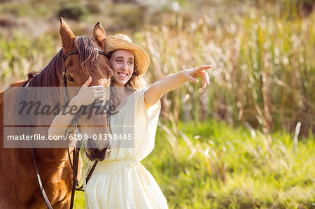 Young happy woman with her horse