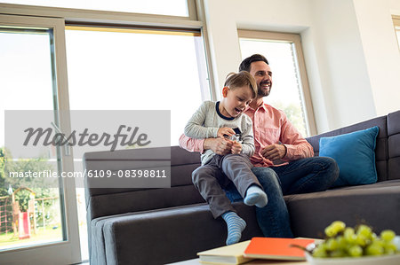 Father and son playing on the couch
