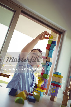 Cute boy playing with building blocks
