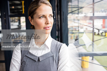 Portrait of a thoughtful businesswoman with arms crossed