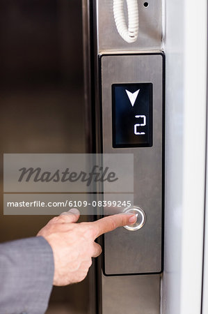 Close up view of businessman pressing elevators button