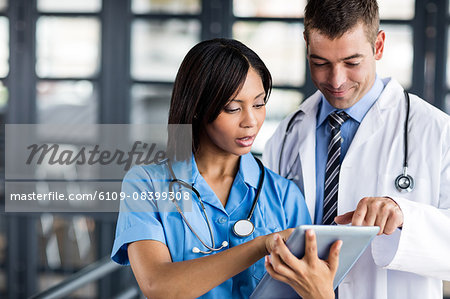 Nurse and doctor looking at a tablet