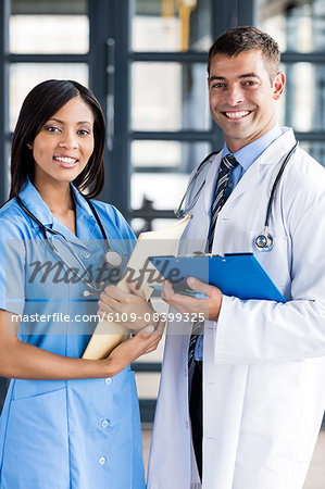 Nurse and doctor holding files