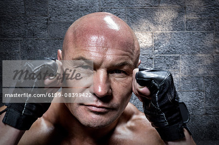 Composite image of close-up of confident man with fighting stance