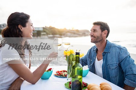 Cute couple having dinner on the beach