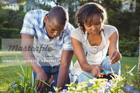 Ethnic couple doing some gardening outside