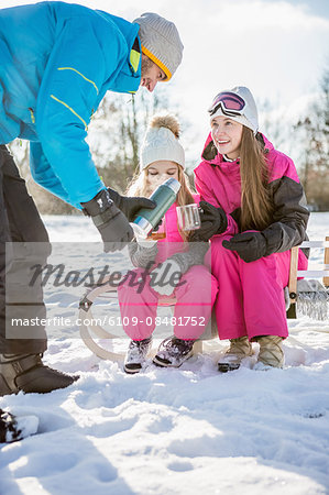 Family drinking tea on a beautiful snowy day Family drinking tea on a beautiful snowy day