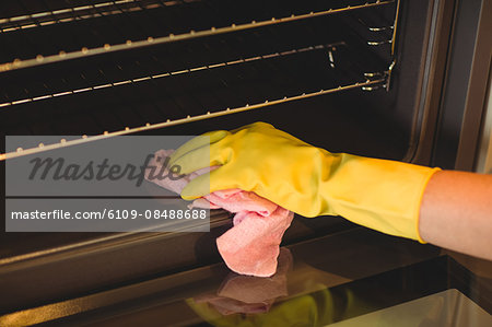 Person cleaning the oven at home