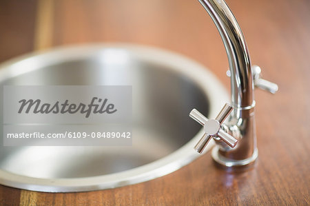 Close up view on a sink on a wooden counter