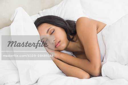 Pretty woman sleeping in bed at home in bedroom