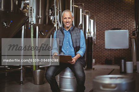 Local brewer reading in the plant at the local brewery