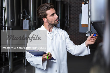 Brewer checking the vats at the microbrewery