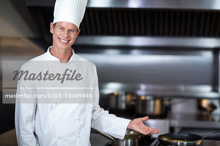 Happy chef smiling at camera in a commercial kitchen