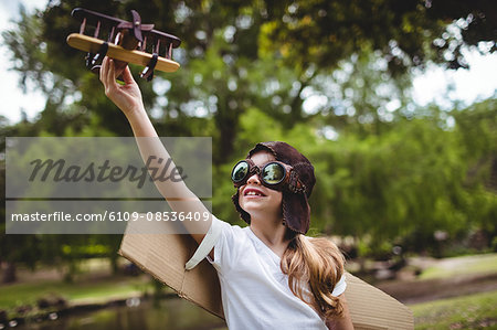 Girl playing with a toy aeroplane