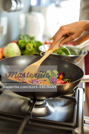 Cropped image of woman cooking food