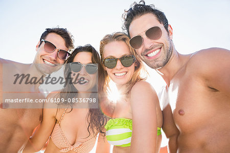 Portrait of smiling friends on the beach