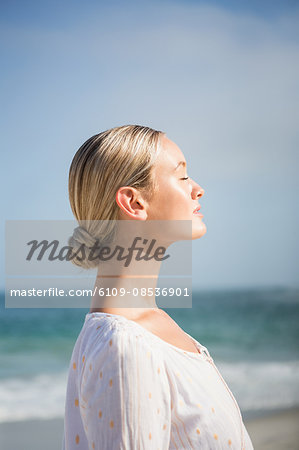 Pretty blonde woman closing her eyes