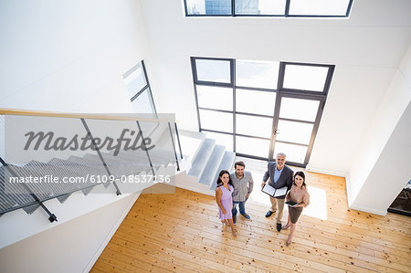 Real estate agent showing new house to couple Real estate agent showing new house to couple