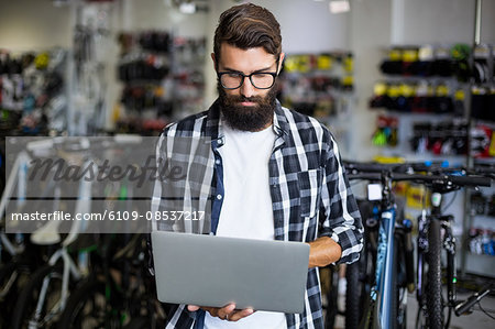 Bike mechanic checking laptop