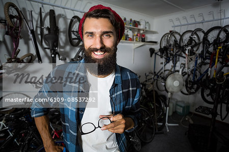 Bike mechanic holding glasses