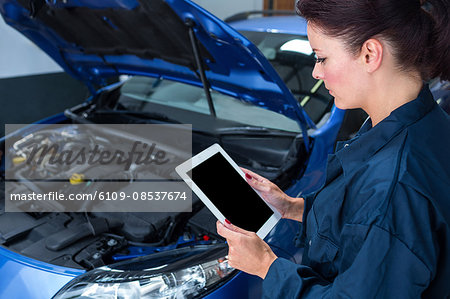 Female mechanic with digital tablet