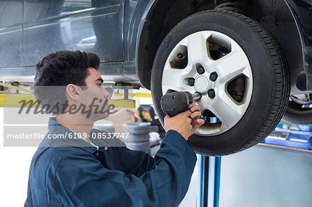 Mechanic fixing a car wheel