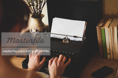 Young woman using typewriter Young woman using typewriter