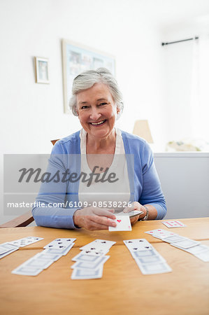 Senior woman playing cards