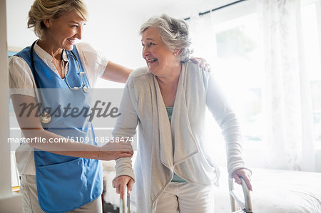 Nurse helping senior woman to stand up Nurse helping senior woman to stand up