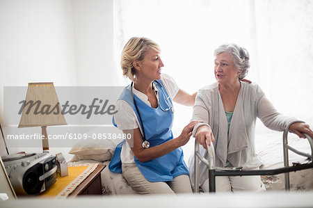 Nurse helping senior woman to stand up Nurse helping senior woman to stand up