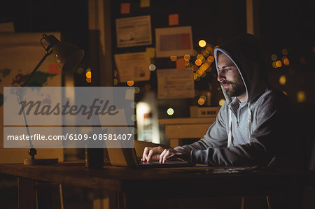 Man using laptop at night