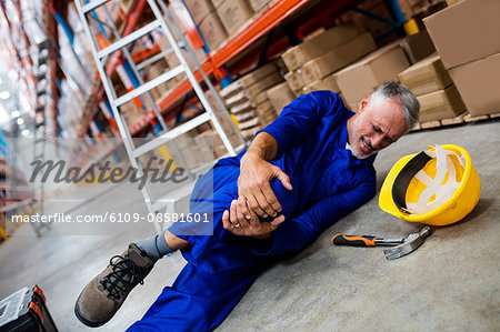 Worker lying and suffering on the floor