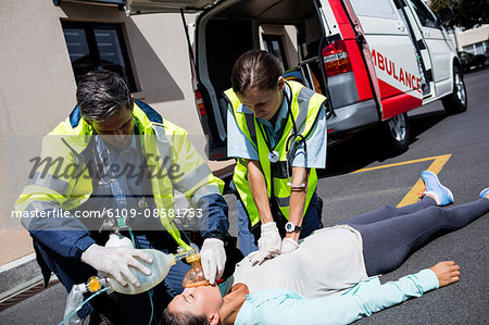 Ambulance men taking care of injured people
